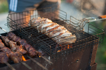 shish kebab on the grill. Marinated shashlik preparing on a barbecue grill over charcoal.