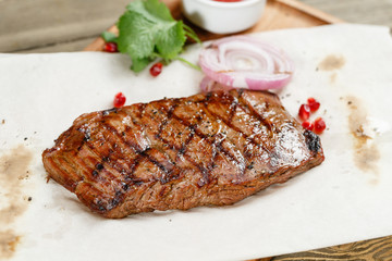 steak of marble beef, grilled. Serving on a wooden Board on a rustic table. Barbecue restaurant menu, a series of photos of different meats