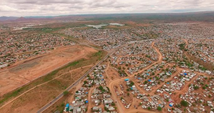 A bird's-eye view taken over a city with ruined houses in Namibia, Africa. The poor people live in these slums. Houses were taken off in a sunny summer in Africa with the help of a drone 4K