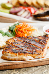 pork steak grill. Serving on a wooden Board on a rustic table. Barbecue restaurant menu, a series of photos of different meats
