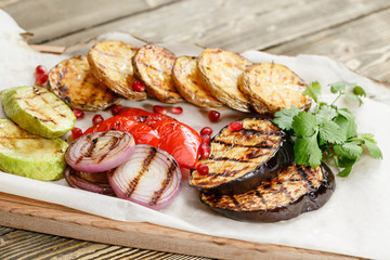 grilled vegetables. Serving on a wooden Board on a rustic table. Barbecue restaurant menu, a series of photos of different dishes