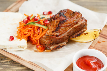 Beef ribs grill. Serving on a wooden Board on a rustic table. Barbecue restaurant menu, a series of photos of different meats