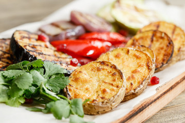 grilled vegetables. Serving on a wooden Board on a rustic table. Barbecue restaurant menu, a series of photos of different dishes