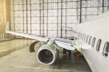 View of the wing and engine of the aircraft repair in the hangar.