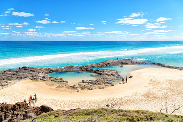  the beach near the rocks in the wave of  ocean