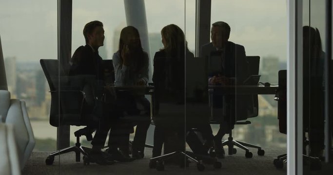 4K Business team having heated discussion boardroom meeting in city office. Slow motion.
