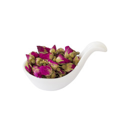 Rose buds tea, tea cup, strainer and glass jar with rosebuds.