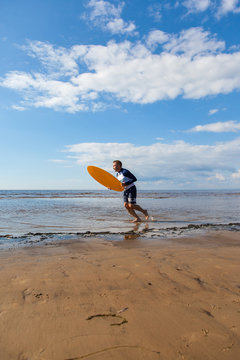 Young man skimboarding