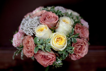Wedding bouquet with yellow and orange roses on wooden background.Close-up. Top view.