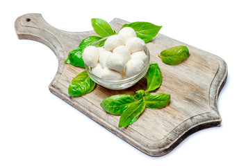 Traditional Italian Mozzarella cheese and basil on white background