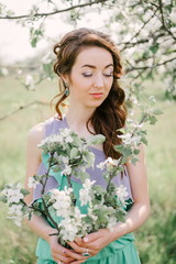 girl with closed eyes and apple tree in hands