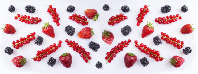 Ripe red currants, strawberries and blackberries on a white background. Mixed berries with copy space for text. Black and red berries. Various fresh summer berries on white. Top view.