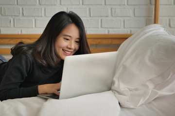 happy smiling woman working with laptop computer at home