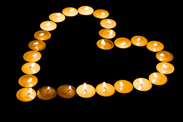 Burning candles in the form of heart