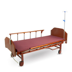Modern automatic bed for a hospital for people with little mobility with a remote control isolated on a white background