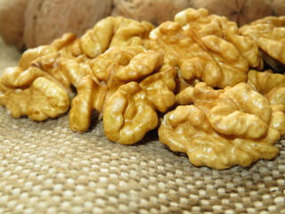 Walnut kernels on burlap. Peeled and unpeeled nuts closeup