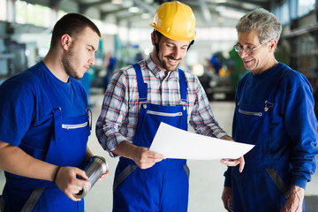 Team Of Engineers Having Discussion In Factory