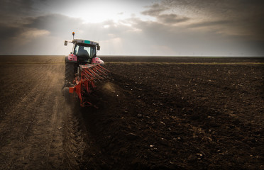 Tractor plowing fields -preparing land for sowing in autumn