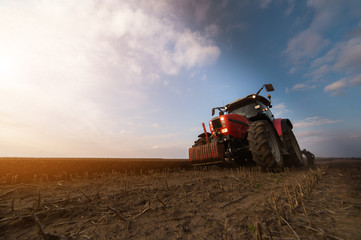 Tractor plowing fields -preparing land for sowing in autumn