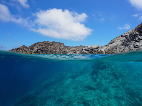 Rocky coastline and rock underwater, split view above and below water surface, Cap de Creus, Mediterranean sea, Spain, Costa Brava, Catalonia