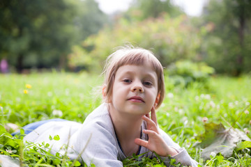 girl   resting on   green meadow