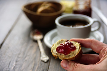 Breakfast with coffee, bread, butter and jam