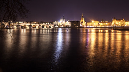 Fototapeta na wymiar Charles Bridge and buildings along the Vltava at night, in Prague, Czech Republic