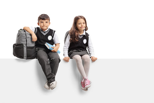Schoolboy and a schoolgirl sitting on a panel