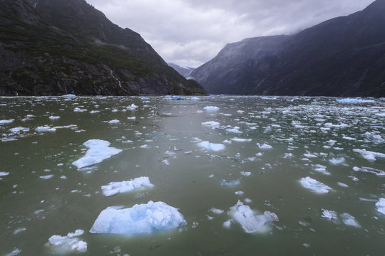 Heavy ice near face of South Sawyer Glacier, misty conditions, mountain backdrop, Tracy Arm Fjord, Alaska
