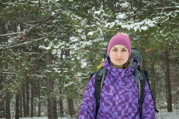 Woman Hiking with Big Backpack in Beautiful Winter Forest