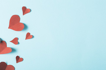 Paper hearts on blue background 