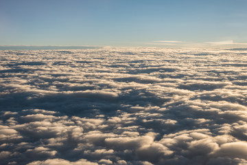 Beautiful view of cloud and sky from the windows of airplane flying when the sunrise