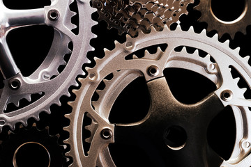 Close-up of various types of bicycle gears on black background