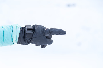 Hand in winter glove gesture pointing with index finger