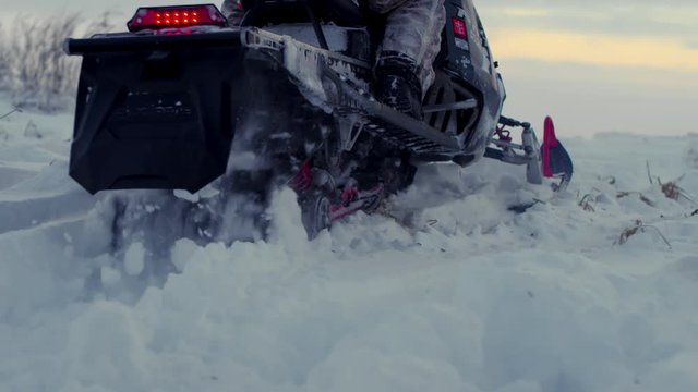 A snowmobile is starting riding on the snow