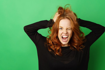 Frustrated redhead woman snarling at the camera