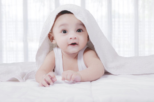 asian baby under blanket