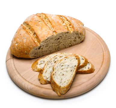 Freshly Baked Bread On Wooden Cutting Board Isolated On White Background.