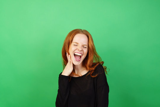 Young woman with red hair laughing