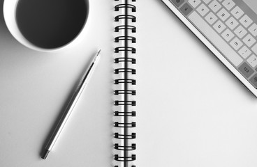 Working office and Business background, tablet, computer, laptop, pen and cup of coffee on the white paper book.