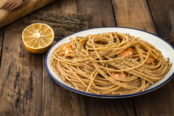 whole wheat spaghetti with shrimp on wood

