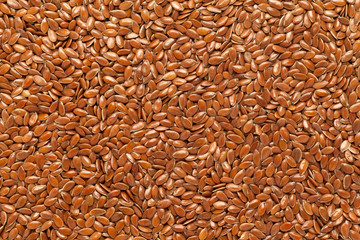Organic flax seeds (Linum usitatissimum) or linseed in full frame background. Micro Closeup, Top view.
