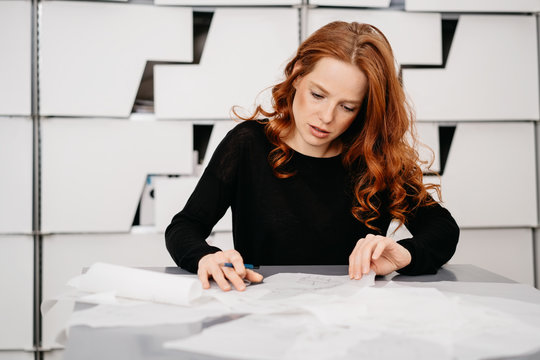 Businesswoman sorting through a pile of papers