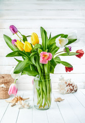 Bouquet spring tulip at white wooden board in rustic style