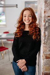 Fototapeta premium Amused young woman chuckling at the camera