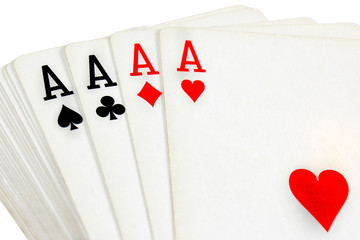 Full deck of playing cards with four aces on top, isolated on white background