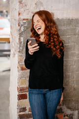 Young redhead woman laughing merrily