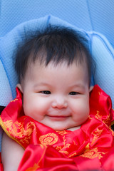 Close up of happy Chinese baby in perambulator baby stroller