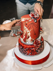 Wedding in the style of rock. Rocker or Biker wedding. Guys with stylish leather jackets. It's a rock'n'roll baby! A sweet couple is cutting a wedding cake.