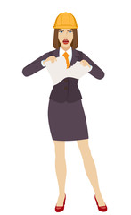 Businesswoman in construction helmet  tearing paper